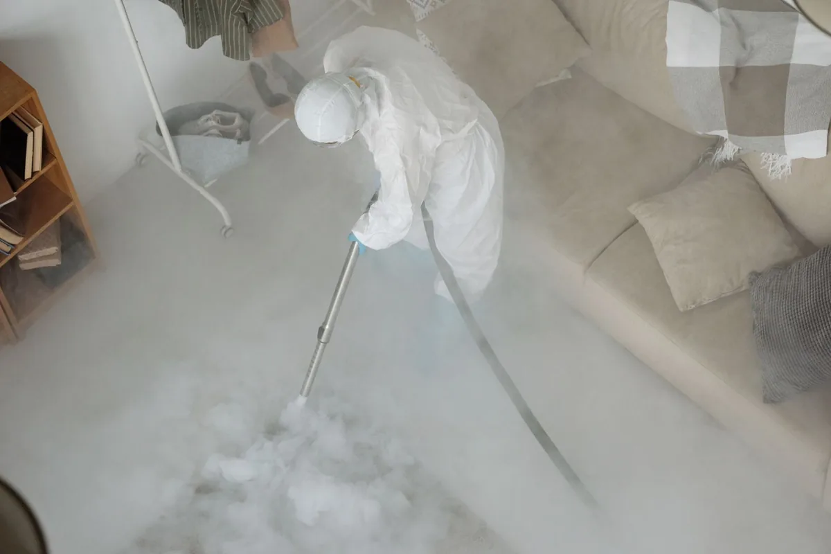 Biohazard cleanup technician in protective equipment, North Hills, NY